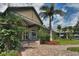 Community clubhouse exterior with lush landscaping and palm trees at 3177 Charles Macdonald Dr, Sarasota, FL 34240