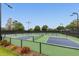 Multiple pickleball courts with green fencing and landscaping at 3177 Charles Macdonald Dr, Sarasota, FL 34240