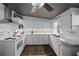 White kitchen with updated appliances and dark gray ceiling at 3524 Bahia Vista St, Sarasota, FL 34239