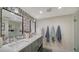 Spa-like bathroom with double vanity and patterned wallpaper at 3745 Almeria Ave # 3S, Sarasota, FL 34239