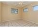 Bright bedroom with tile floors and ceiling fan at 3855 Monica Pkwy, Sarasota, FL 34235