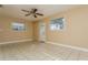 Spacious living room with ceiling fan and tile flooring at 3855 Monica Pkwy, Sarasota, FL 34235