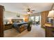King-size bedroom with access to a patio and lots of natural light at 4330 Falmouth Dr # 108, Longboat Key, FL 34228