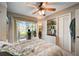 Main bedroom with a queen bed, built-in shelving, and access to a balcony at 4330 Falmouth Dr # 108, Longboat Key, FL 34228
