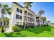 Building exterior showcasing manicured lawn and tropical landscaping at 4330 Falmouth Dr # 108, Longboat Key, FL 34228