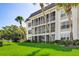 Two-story condo building with balconies and lush landscaping at 4330 Falmouth Dr # 108, Longboat Key, FL 34228