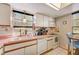 Updated kitchen with pink countertops, white cabinets, and a window above the sink at 4330 Falmouth Dr # 108, Longboat Key, FL 34228