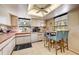 Cozy kitchen with white cabinets, pink countertops, and breakfast bar at 4330 Falmouth Dr # 108, Longboat Key, FL 34228
