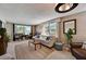 Spacious living room with large windows, comfortable seating, and a cozy atmosphere at 4330 Falmouth Dr # 108, Longboat Key, FL 34228
