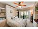 Spacious main bedroom with a queen bed, built-in shelves, and sliding glass doors to a patio at 4330 Falmouth Dr # 108, Longboat Key, FL 34228