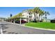 Condo building with covered parking and lush green landscaping at 4330 Falmouth Dr # 108, Longboat Key, FL 34228