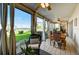 Sunroom with water view and comfortable seating at 4330 Falmouth Dr # 108, Longboat Key, FL 34228