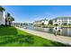 Peaceful waterfront walkway with canal views and green grass at 4330 Falmouth Dr # 108, Longboat Key, FL 34228