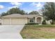 House exterior, three car garage, landscaped lawn at 4563 Bayridge Ct, Spring Hill, FL 34606