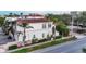 Aerial view of townhomes showing red tile roofs, manicured landscaping, and the surrounding neighborhood at 461 Nokomis S Ave, Venice, FL 34285