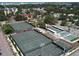 Aerial view of the community amenities, including tennis courts, pickleball, and basketball, surrounded by greenery at 461 Nokomis S Ave, Venice, FL 34285