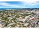 Scenic aerial view of a town with the ocean and bay, surrounded by lush greenery and clear blue skies at 461 Nokomis S Ave, Venice, FL 34285