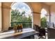 Inviting outdoor balcony with a view of lush greenery, furnished with a dining table and seating at 461 Nokomis S Ave, Venice, FL 34285
