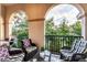 Lovely balcony view complete with comfortable wicker seating and ornate black railings at 461 Nokomis S Ave, Venice, FL 34285