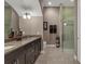 Modern bathroom with double sinks, a large mirror, and a glass-enclosed shower at 461 Nokomis S Ave, Venice, FL 34285
