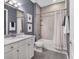 Well-lit bathroom featuring a vanity with a marble countertop and a shower-tub combination at 461 Nokomis S Ave, Venice, FL 34285