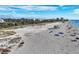 Gorgeous white sand beach with clear water and activities under a blue sky at 461 Nokomis S Ave, Venice, FL 34285