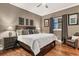 Comfortable bedroom featuring a king-sized bed, hardwood floors, and elegant decor at 461 Nokomis S Ave, Venice, FL 34285