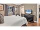 Bedroom with hardwood flooring and a television on the dresser, with a view into the ensuite at 461 Nokomis S Ave, Venice, FL 34285