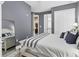 Bedroom with a queen-sized bed and blue and white bedding, leading to bathroom at 461 Nokomis S Ave, Venice, FL 34285