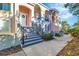 Charming townhome exterior featuring arched entryways, wrought iron railings, and a welcoming front door with wreath at 461 Nokomis S Ave, Venice, FL 34285