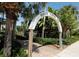Entrance to the Venice Fishing Pier among lush tropical landscaping on a sunny day, offering a scenic recreational spot at 461 Nokomis S Ave, Venice, FL 34285