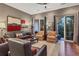 Spacious living room with hardwood floors, comfortable seating, a ceiling fan, and balcony access at 461 Nokomis S Ave, Venice, FL 34285
