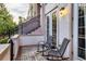 Charming outdoor patio with stone pavers, seating for two, and access to upper level stairs at 461 Nokomis S Ave, Venice, FL 34285