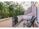 Cozy patio featuring stone pavers, private seating, and a small gate leading to green space at 461 Nokomis S Ave, Venice, FL 34285
