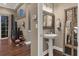Elegant powder room featuring a pedestal sink and decorative mirrors at 461 Nokomis S Ave, Venice, FL 34285