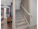 Carpeted staircase leading to the upper level of the home, with access to different rooms at 461 Nokomis S Ave, Venice, FL 34285