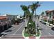 Charming street with beautiful buildings, lined with lush palm trees, offering a vibrant and inviting atmosphere at 461 Nokomis S Ave, Venice, FL 34285