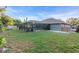 Large grassy backyard with screened pool at 4877 Post Pointe Dr, Sarasota, FL 34233