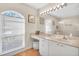 Bathroom with vanity, large mirror, and tiled floor at 4877 Post Pointe Dr, Sarasota, FL 34233