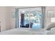 Bedroom with sliding glass doors opening to a pool view at 4877 Post Pointe Dr, Sarasota, FL 34233