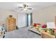 bedroom with twin bed, dresser, and ceiling fan at 4877 Post Pointe Dr, Sarasota, FL 34233