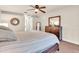 Spacious bedroom with a king-size bed, dresser, and ceiling fan at 4877 Post Pointe Dr, Sarasota, FL 34233