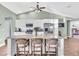 Eat-in kitchen with granite countertops, white cabinets, and hardwood floors at 4877 Post Pointe Dr, Sarasota, FL 34233