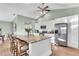 Modern kitchen with white cabinets, granite island, and stainless steel appliances at 4877 Post Pointe Dr, Sarasota, FL 34233