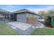 Brick paved patio with pebble border and wooden wall at 4877 Post Pointe Dr, Sarasota, FL 34233