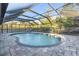 Relaxing kidney-shaped pool with covered patio at 4877 Post Pointe Dr, Sarasota, FL 34233