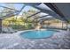 Inviting pool area with covered patio and lounge chairs at 4877 Post Pointe Dr, Sarasota, FL 34233