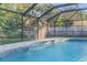 Refreshing screened pool with a waterfall feature at 4877 Post Pointe Dr, Sarasota, FL 34233