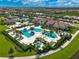 Aerial view of community pool, tennis courts, and residential homes at 5035 Kiva Cir, Bradenton, FL 34211