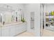Elegant bathroom with a double vanity, large mirror, and walk-in closet at 5035 Kiva Cir, Bradenton, FL 34211